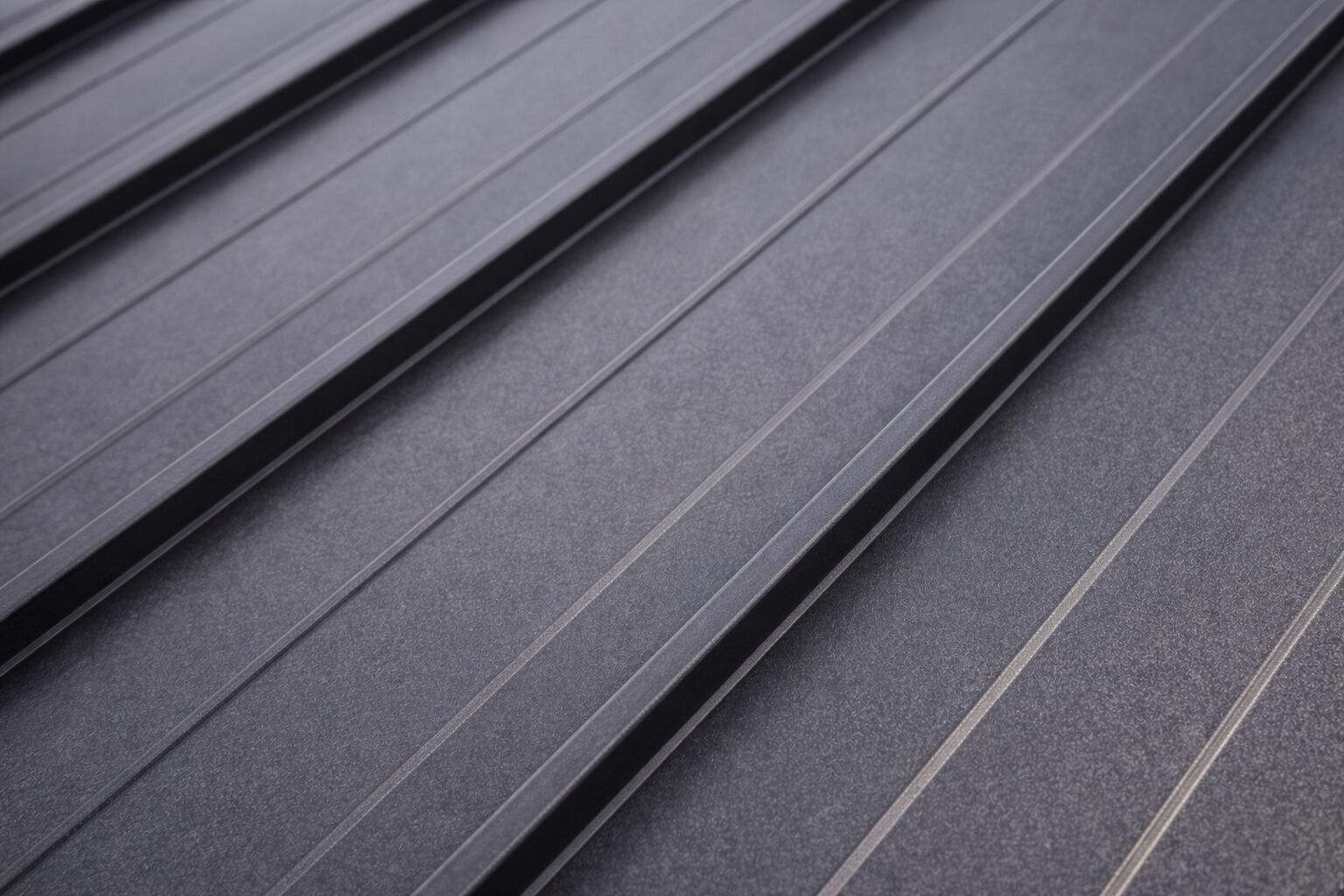 Close view of a standing seam metal roof panel and its raised interlocking seam